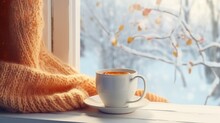Cozy Winter Still Life: Mug Of Hot Tea And Warm Woolen Knitting On Vintage Windowsill Against Snow Landscape From Outside. .