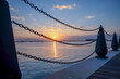 Sunrise in the old port of Doha, the sun appears with the iron chains of the port wall, Qatar