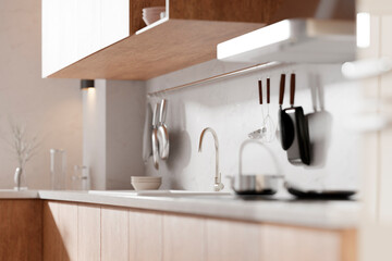 A bright beige-toned kitchen interior with sunlight 
coming through the window.