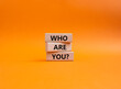 Who are You symbol. Concept words Who are You on wooden blocks. Beautiful orange background. Business and Who are You concept. Copy space.