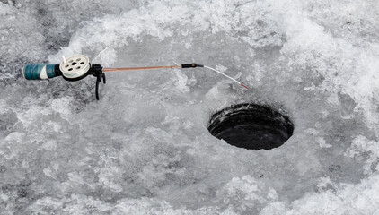 Sticker - Fishing rod on ice in winter. Ice fishing