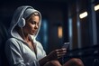 Beautiful young woman listening to music with headphones while sitting in the gym, Attractive athletic woman in headphones wearing towel on her shoulders and using smart phone, AI Generated