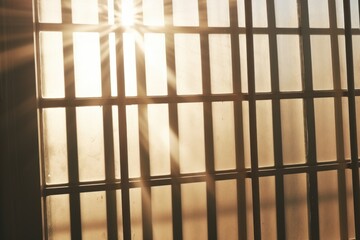 Poster - A jail cell with the sun shining through the bars. Can be used to depict imprisonment, confinement, or the hope of freedom