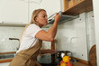 © Atlas - A young woman is preparing breakfast in the kitchen