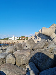 Canvas Print - Jeju Island beach with breakwater and basalt rocks.