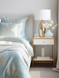 Silk bedding on a bed with a nightstand and lamp, delicate interior in the style of light gold and light azure