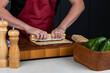 Sushi chef hands making Japanese food. Man cooking sushi at restaurant or at home. Traditional asian rolls on cutting board. Maki sushi with tuna, omelette, cheese and vegetables