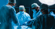 © Acronym - Team of medical doctors performs surgical operation in modern operating room using high-tech technology. Surgeons are working to save the patient in the hospital. Medicine, health and science.