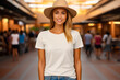 Woman wearing hat and jeans in mall.