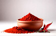 Chilly powder with red chilly in clay pots on white background