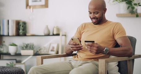 Poster - Man, phone and credit card on sofa with banking for online shopping, fintech and internet payment in living room. Black person, smartphone and happy for web transaction or discount on sale website