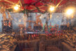 A market stall, seen through rain spattered protective plastic sheeting, produces a dreamy, abstract effect