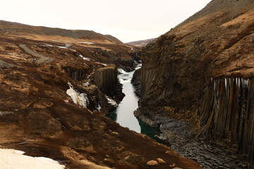 Stuðlagil is a ravine in Jökuldalur in the municipality of Múlaþing, in the Eastern Region of Iceland. It is known for its columnar basalt rock formations and the blue-green water that runs through it