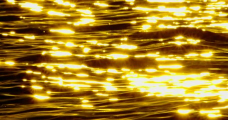 Wall Mural - Water wave Reflection sunset of sunlight over lake surface in slow motion. Cinematic scene water reflection golden wave background. High quality footage 4k ProRes422
