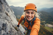 A beautiful young rock climbing woman climbs a rock wall.