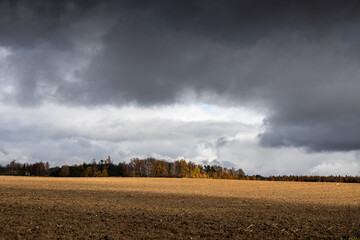 Sticker - Heavy clouds above autumn plowed field