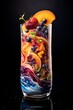 A clear glass filled with a swirling galaxy of colorful fruit smoothie