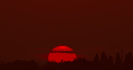 Wall Mural - Big Sunrise Timelapse video Close-up the sun in red cloud sky over horizontal.ProRes422