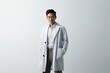 © nialyz - asian male doctor in white coat standing and looking at camera isolated on white
