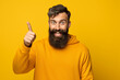 © Uzair - hispanic handsome man laughing, looking happy, positive and surprised, realizing a great idea pointing