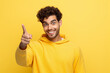 © Uzair - hispanic handsome man laughing, looking happy, positive and surprised, realizing a great idea pointing