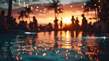 Blurred View Of People Reveling In The Festivities At A Beach Party By Swimming Pool
