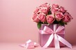 A beautiful bouquet of roses in a gift box with a satin bow