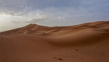Fototapeta  - 04_Sunrise of the famous and legendary dunes of Erg Chebbi in the Sahara Desert, Morocco.