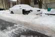 Car parked on snow-covered street after snow removal in winter