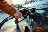 Fototapeta  - a close up image of a hand filling up a car with gas at a gas station