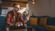 © Miljan Živković - One adult man at home use smart phone app browse internet or send sms
