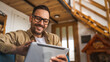 © Miljan Živković - One Man caucasian Holding Digital Tablet work at home Happy Smile