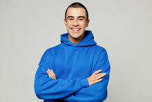 Young Smiling Happy Cheerful Middle Eastern Man He Wears Blue Hoody Casual Clothes Hold Satisfied Hands Crossed Folded Look Camera Isolated On Plain Solid White Background Studio. Lifestyle Concept.