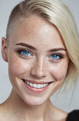 Wall Mural - Portrait of a beautiful blonde smiling woman.Freckles, blue eyes.Short haircut.Close-up.Authentic appearance.Fashion glamour art.