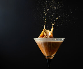 Wall Mural - Espresso Martini drink with splashes on a black background.