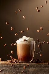 Poster - Coffee and chocolate drink with whipped cream on a brown background.