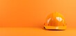 orange safety helmet in photo on orange Background