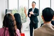 © sorapop - During a conference, a diverse crowd of businesspeople raises their hands to ask questions, vote, or volunteer. This scene emphasizes teamwork and active audience involvement.