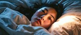 Fototapeta  - Insomnia is common among Asian women lying in bed with open eyes.