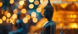 Fototapeta  - Buddha in Thai temple with bokeh backdrop.