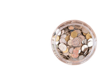 top view of Thai coins in transparent plastic jar isolated on white background. Concept of saving money for the future or money growth