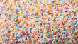 colorful tiny dessert candy topping; rainbow sprinkle dots background