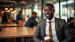 © Old Man Stocker - African American businessman dressed in a sharp, tailored suit, seated comfortably in a modern coffee shop.