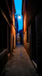Narrow alleyway in Venice, Italy at dusk or dawn.