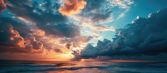 Canvas Print - Colorful sunset over the ocean with clouds in various shades.