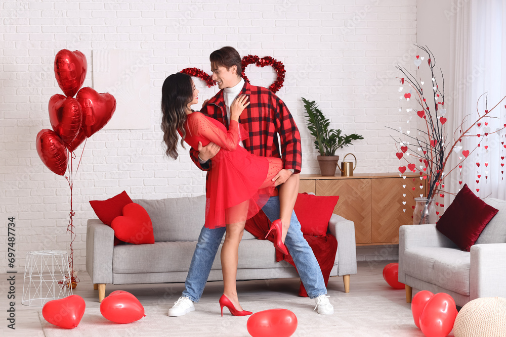 Young couple dancing at home on Valentine's Day
