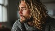 © mariiaplo - Blonde long hair handsome man in grey sweater at home