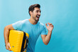 © SHOTPRIME STUDIO - Traveler man yellow journey flight trip baggage studio suitcase guy travel vacation happy weekend background
