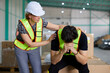 male worker feeling tired from work and coworker helping him in the warehouse storage