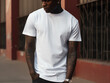 A black man with tattoos wearing a white T-shirt, posing for a mockup